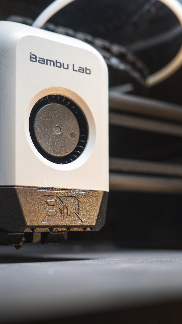 Close-up of a 3D printer head building an object layer by layer